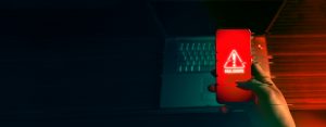 Anonymous hacker uses malware with mobile phone hack password personal data money from bank accounts concept cyber crime 300x117