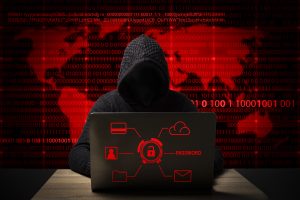 Hacker jacket with hood with laptop sits table 300x200